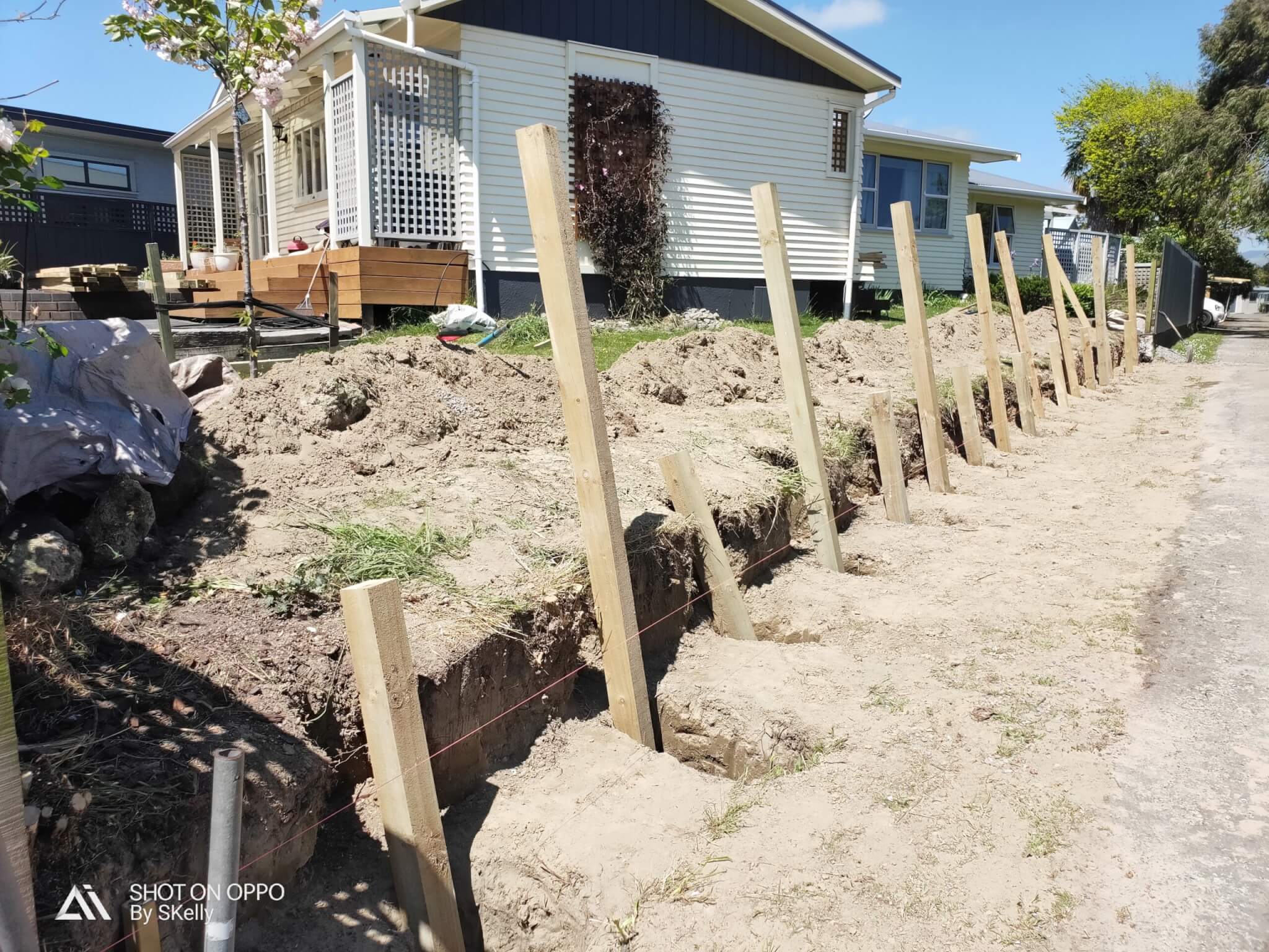 post holes for retaining wall scaled